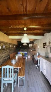 a kitchen with a large wooden table and chairs at My Grandmas A casa das avós in Vale de Figueira