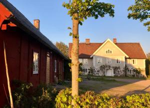a house with a tree in front of it at Ängaröds Gård in Ljungbyhed