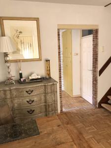 um quarto com uma cómoda, um espelho e uma porta em Huisje De Koning em Zandvoort