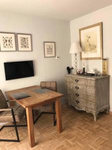 a living room with a wooden table and a dresser at Huisje De Koning in Zandvoort