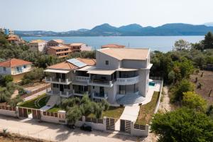 an aerial view of a large house with a lake at Aurora Studios in Nikiana