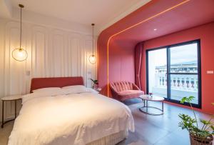 a bedroom with a large bed and a large window at Olivia Boutique Hotel in Sanxing