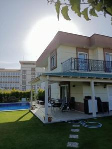 a large house with a patio and a pool at Villa Leon in Reisdere