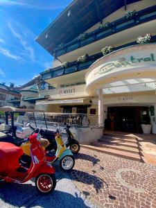 a row of scooters parked in front of a building at Hotel Central in Gerlos