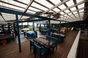 a restaurant with tables and chairs and a roof at Kaunissaaren Maja in Kotka