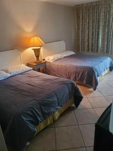 Postel nebo postele na pokoji v ubytování Conty's Motel
