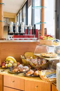 a buffet with many plates of food on a counter at Hotel Fiorita in Florence