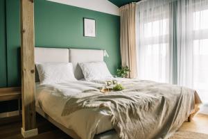 מיטה או מיטות בחדר ב-Apartamenty Las