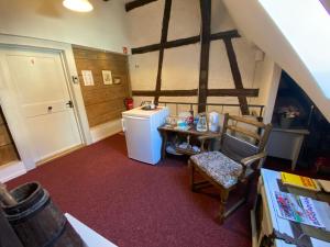 a kitchen with a refrigerator and a table and a chair at Pension Jeske Heidelberg in Heidelberg
