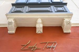 a building with a statue on top of it at Lady Todd in Sliema