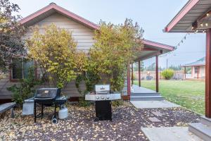 une arrière-cour avec un barbecue et une maison dans l'établissement Pinedale Cozy Cabins, à Pinedale