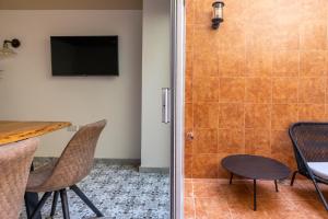 a bathroom with a shower and a table and chairs at Lady Todd in Sliema