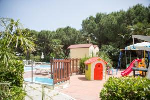 a playground with a slide and a play structure at Hotel Gaudia in Riccione