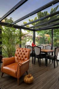 a conservatory with a couch and a table and chairs at Lagun Palas in Yalova