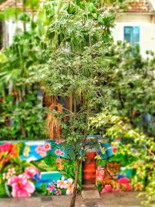 a small tree in a garden with a bench at Mango Tree Ipanema in Rio de Janeiro