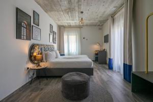 a bedroom with a bed and a table and a stool at Lady Todd in Sliema