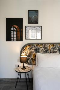 a bedroom with a bed and a table with a lamp at Lady Todd in Sliema