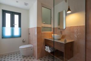 a bathroom with a toilet and a sink and a mirror at Lady Todd in Sliema