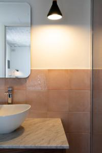 a bathroom with a bowl sink and a mirror at Lady Todd in Sliema
