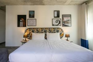 a bedroom with a large white bed with two pillows at Lady Todd in Sliema