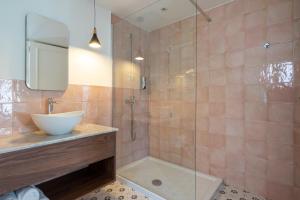 a bathroom with a sink and a shower at Lady Todd in Sliema +15 photos