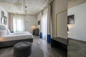 a bedroom with a bed and a chair in it at Lady Todd in Sliema