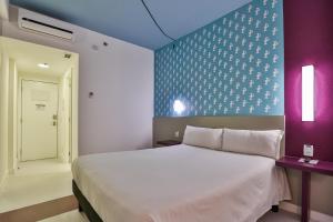 Cama ou camas em um quarto em Nobile Inn Pampulha