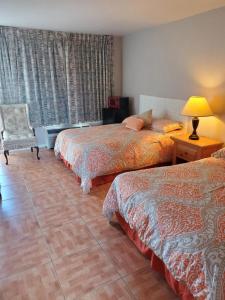 Postel nebo postele na pokoji v ubytování Conty's Motel