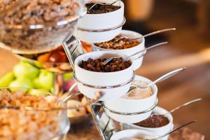 a tiered buffet with bowls of nuts and other food at Jochum Hotel Garni in Fiss