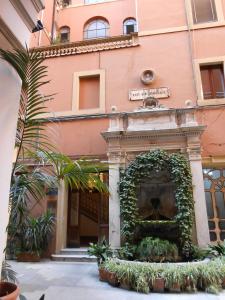 a building with a fountain in front of a building at Magnifico Rome in Rome