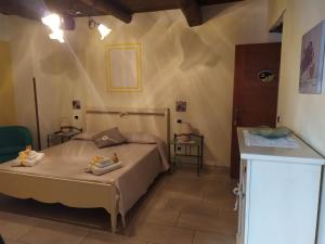 a bedroom with a bed and two tables in a room at B&B La Carosella in Vatolla