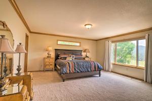 a bedroom with a bed and a window at Cripple Creek Mtn Getaway with Panoramic Views in Cripple Creek