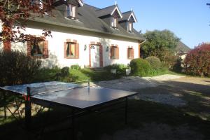a ping pong table in front of a house at Le colibri in Étretat