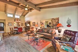 a living room with leather furniture and a table at Sedona Home with Golf Course View and Pool Access! in Sedona