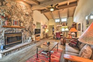 a living room with a large stone wall at Gated Home with Golf Course View and Pool Access! in Sedona