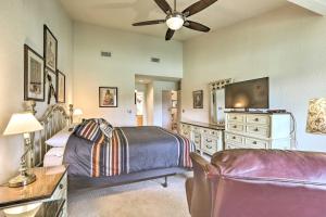 a bedroom with a bed and a flat screen tv at Sedona Home with Golf Course View and Pool Access! in Sedona