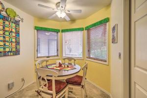a dining room with a table and chairs and windows at Sedona Home with Golf Course View and Pool Access! in Sedona