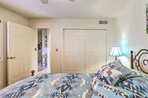 a bedroom with a bed and a lamp and a door at Sedona Home with Golf Course View and Pool Access! in Sedona