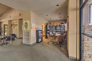 a room with a library with chairs and a table at Sedona Home with Golf Course View and Pool Access! in Sedona