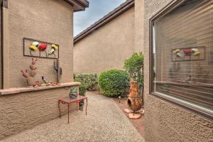 a patio with a table and a window with plants at Sedona Home with Golf Course View and Pool Access! in Sedona
