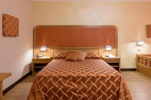 a bedroom with a large bed with two night stands at Leone de Castris Wine Hotel in Salice Salentino