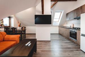 a kitchen and living room with a couch and a table at Villa u Arény in Ostrava