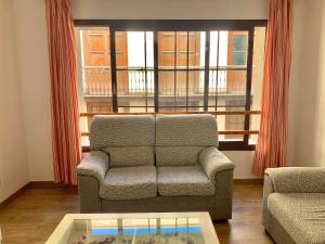 a living room with a couch and a window at Centro Ciudad in Santa Cruz de la Palma