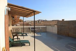 un patio con sillas y una mesa en el techo en A la terrasse d'Avignon en Aviñón