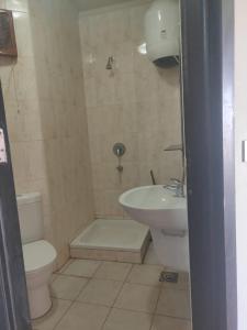 a bathroom with a toilet and a sink at one bedroom chalet porto south Families only in Ain Sokhna