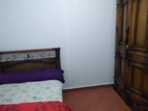 a bedroom with a bed and a wooden cabinet at one bedroom chalet porto south Families only in Ain Sokhna