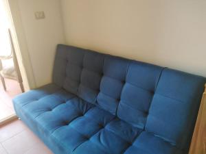 a blue couch in the corner of a room at one bedroom chalet porto south Families only in Ain Sokhna