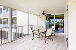 a patio with a table and chairs on a balcony at Duck Key Bliss in Duck Key