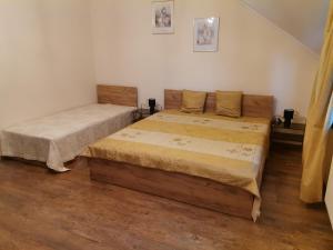 two twin beds in a room with wooden floors at Pod Jesionem in Rachanie
