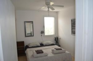 a bedroom with a bed and a ceiling fan at Jerusalem 18 in Acre